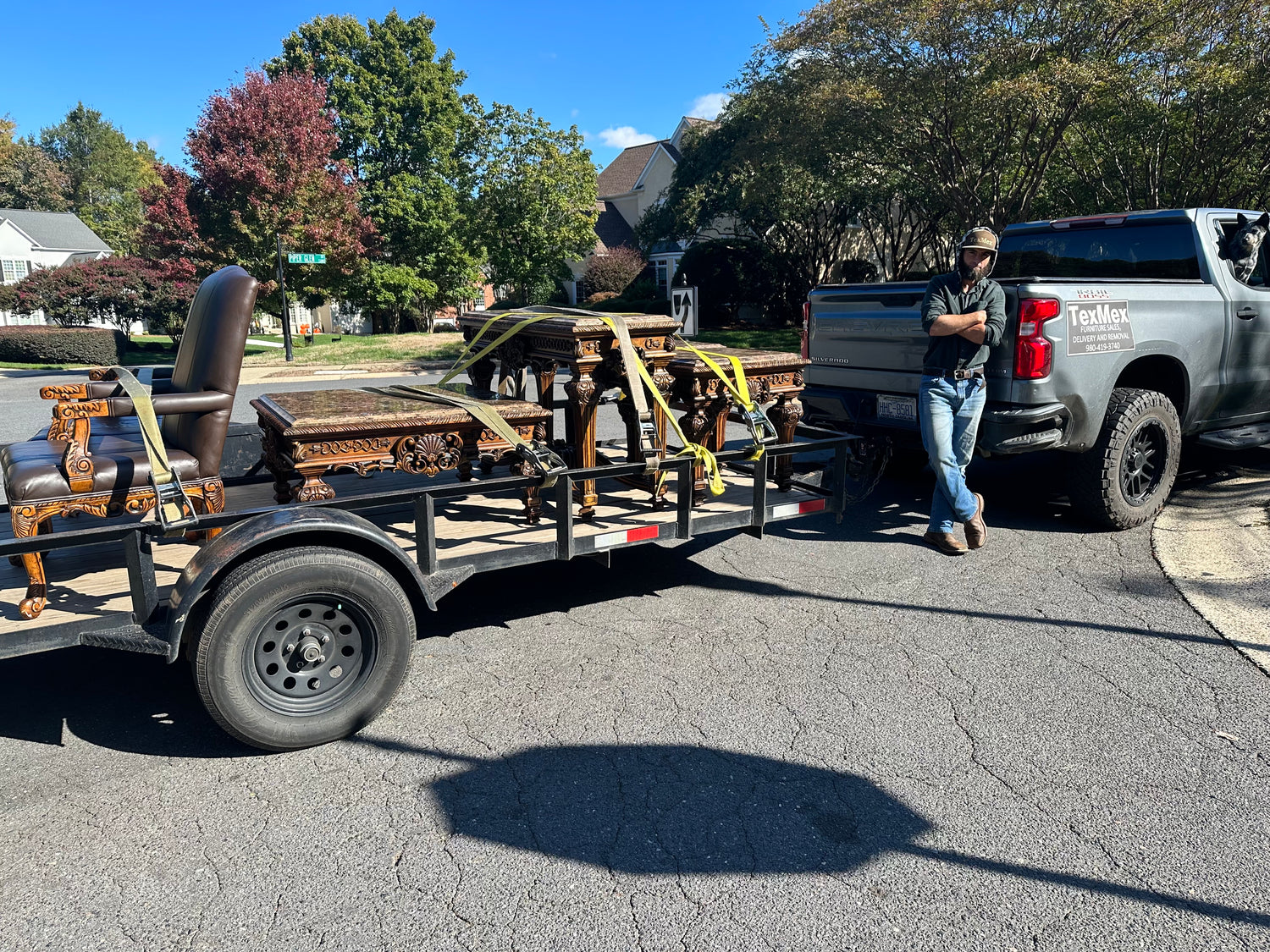 Owner of the Charlotte NC based Small Business TexMex Furniture and Detailing Co standing next to his Work Truck and Trailer after Removing 3 Tables for a Customer